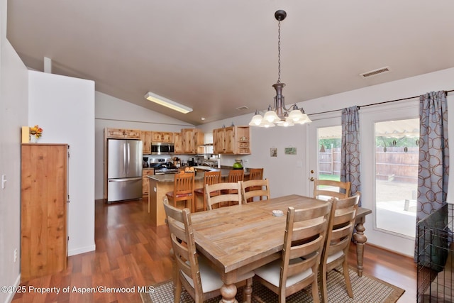 2939 Jon Hall Rd, Grand Junction, CO 81503 - dining area with dark wood-type flooring, lofted ceiling, and a chandelier