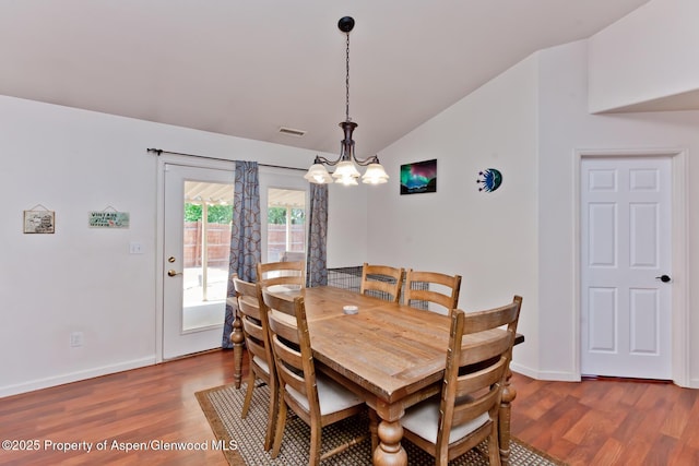 2939 Jon Hall Rd, Grand Junction, CO 81503 - dining room with vaulted ceiling, wood finished floors, a chandelier, and baseboards