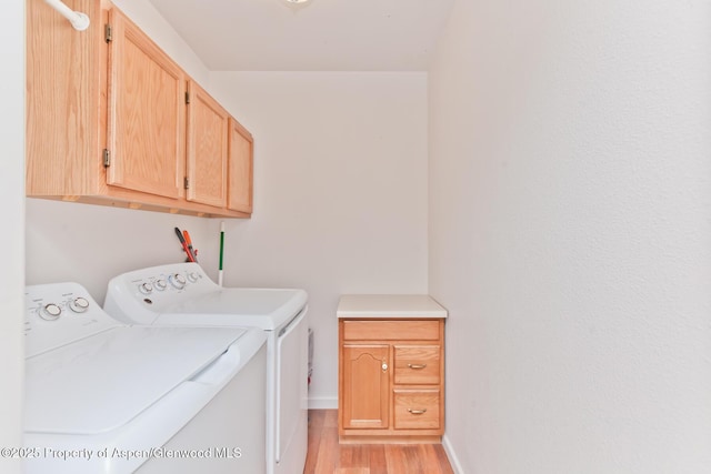 2939 Jon Hall Rd, Grand Junction, CO 81503 - laundry area featuring cabinet space, independent washer and dryer, light wood-type flooring, and baseboards