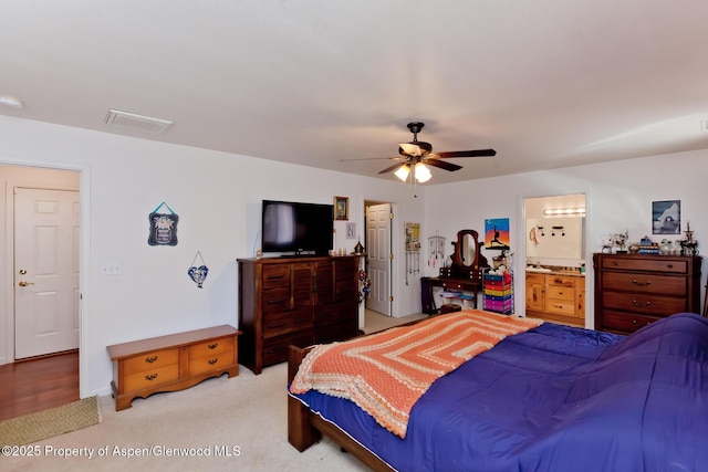 2939 Jon Hall Rd, Grand Junction, CO 81503 - bedroom with light colored carpet, ensuite bath, and ceiling fan