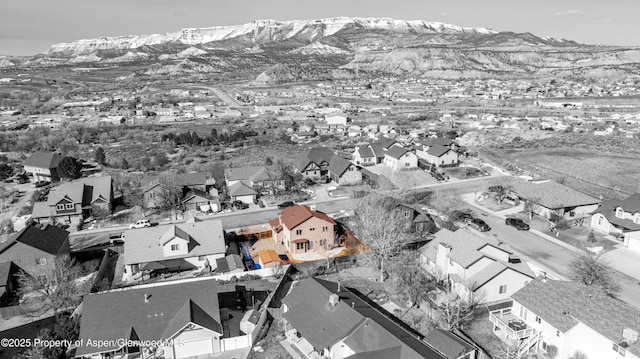drone / aerial view featuring a residential view and a mountain view