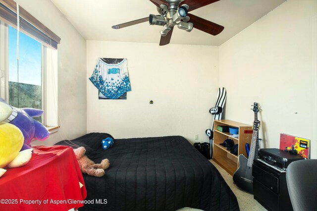 bedroom with ceiling fan and light carpet