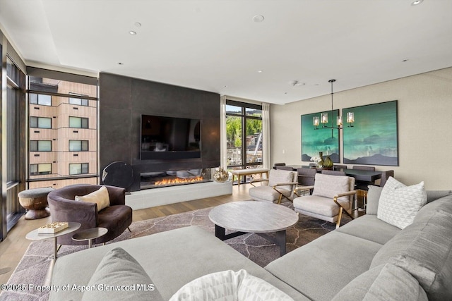 77 Wood Rd Unit 507-10, Snowmass Village, CO 81615 - living area featuring wood finished floors, a large fireplace, recessed lighting, and a chandelier