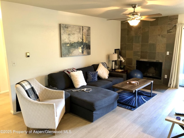 1527 Blake Ave Unit 201, Glenwood Springs, CO 81601 - living room with wood finished floors, a ceiling fan, and a fireplace