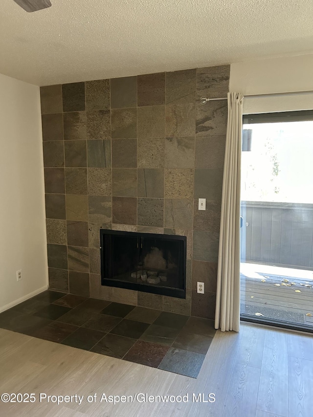 1527 Blake Ave Unit 201, Glenwood Springs, CO 81601 - detailed view of a tile fireplace, wood finished floors, and a textured ceiling