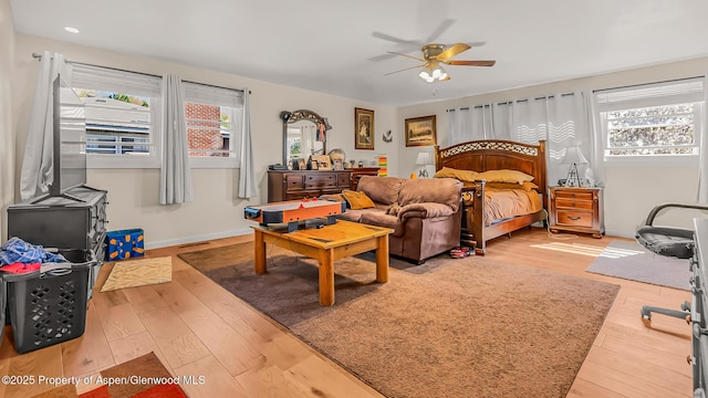 1028 Breeze St, Craig, CO 81625 - bedroom with multiple windows, hardwood / wood-style flooring, ceiling fan, and baseboards