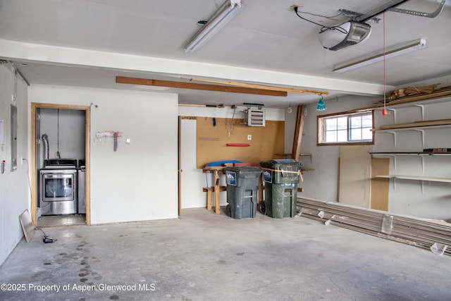 garage featuring a garage door opener and washer and dryer