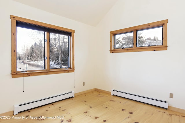 empty room with hardwood / wood-style flooring, lofted ceiling, and baseboard heating