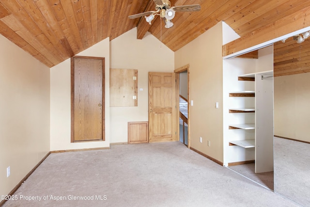 unfurnished bedroom with vaulted ceiling with beams, light carpet, and wood ceiling