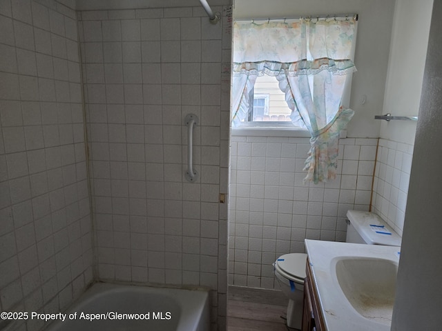 720 Taylor St, Craig, CO 81625 - bathroom featuring toilet, tile walls, vanity, and washtub / shower combination