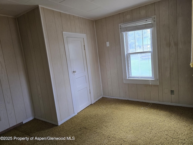 720 Taylor St, Craig, CO 81625 - carpeted empty room featuring wooden walls and baseboards