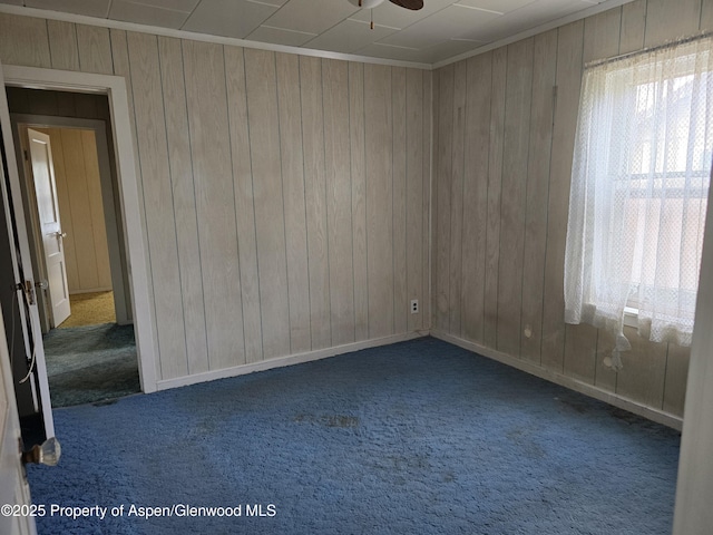 720 Taylor St, Craig, CO 81625 - carpeted spare room featuring wood walls, ceiling fan, and baseboards