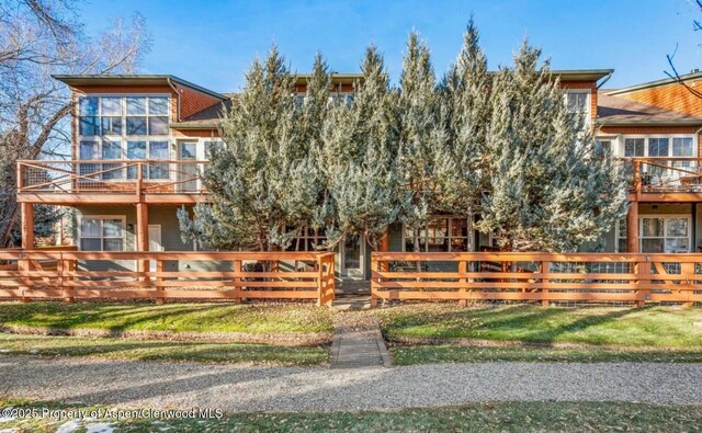 536 Evans Ct, Basalt, CO 81621 - view of front of home with a front lawn, a balcony, and a fenced front yard