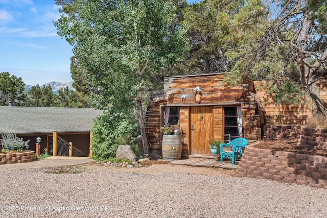 679 Pinon Dr, Basalt, CO 81621 - view of front of property with concrete driveway, an outbuilding, a shingled roof, and an attached garage