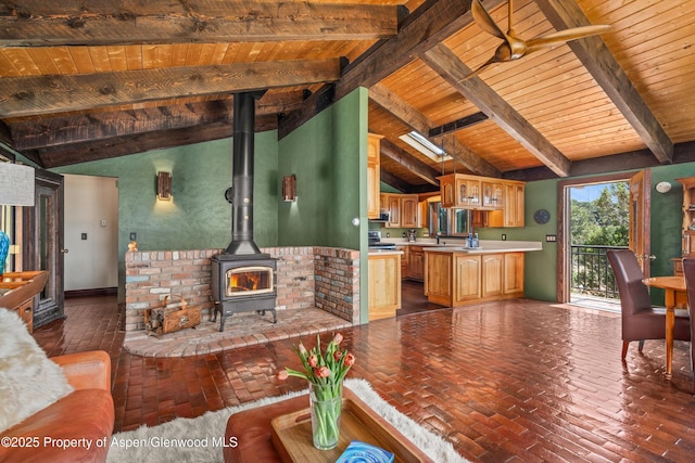 679 Pinon Dr, Basalt, CO 81621 - living room with wood ceiling, a wood stove, and brick flooring