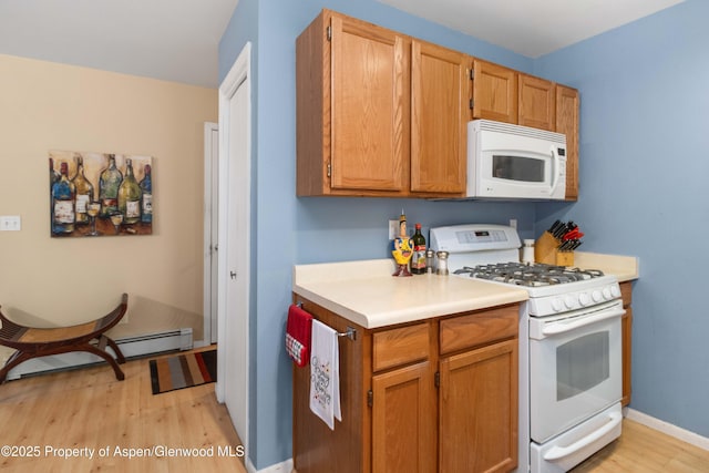 905 Meadow Run, Glenwood Springs, CO 81601 - kitchen with white appliances, light wood finished floors, light countertops, and a baseboard heating unit