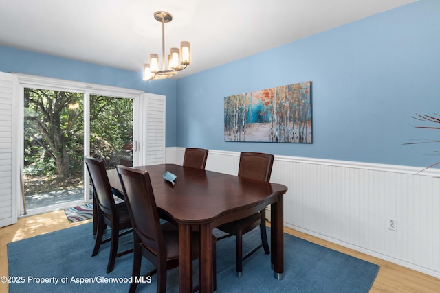 905 Meadow Run, Glenwood Springs, CO 81601 - dining space with a wainscoted wall, a chandelier, and wood finished floors
