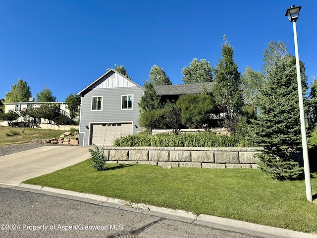 front facade with a front yard and a garage