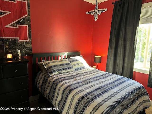 bedroom featuring multiple windows and a chandelier