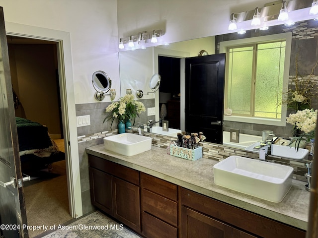 bathroom with tile patterned flooring, vanity, and decorative backsplash