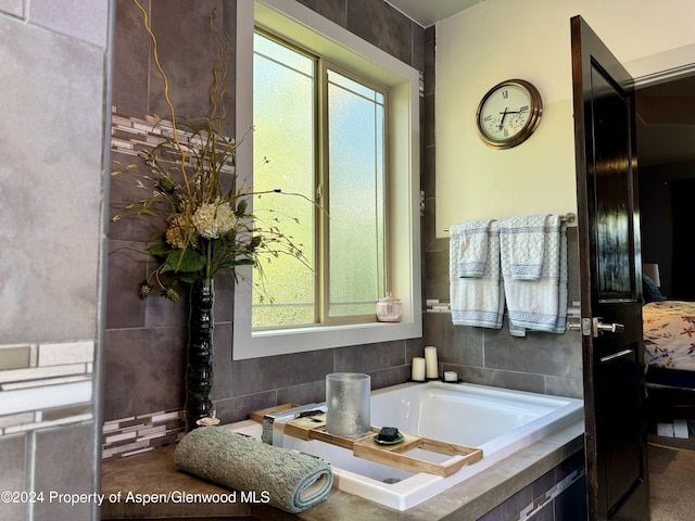 bathroom with a relaxing tiled tub