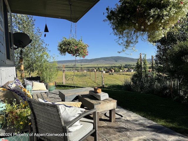 view of patio / terrace with outdoor lounge area, a mountain view, and a rural view