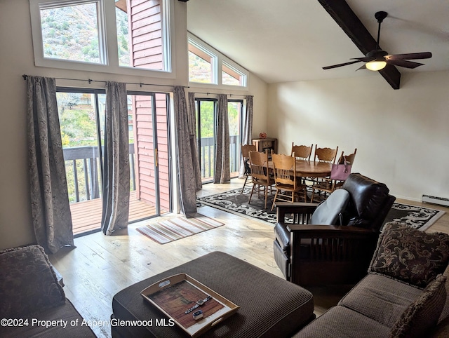 living room featuring hardwood / wood-style flooring, ceiling fan, a healthy amount of sunlight, and a baseboard radiator