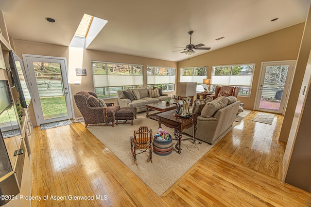 1001 Alta Ct, Craig, CO 81625 - living room with light wood finished floors, vaulted ceiling, a ceiling fan, and a skylight