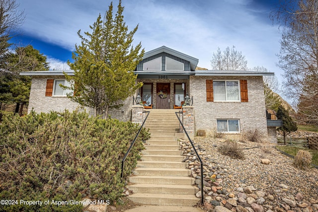 1001 Alta Ct, Craig, CO 81625 - view of front of home featuring brick siding, stairway, and a porch