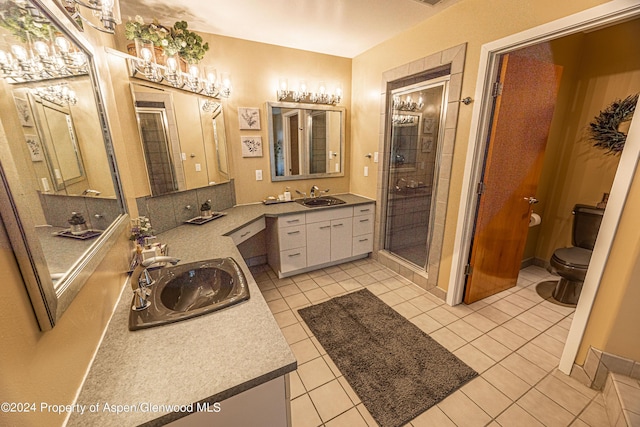 1001 Alta Ct, Craig, CO 81625 - full bath with a stall shower, toilet, two vanities, tile patterned flooring, and baseboards