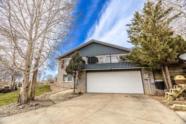1001 Alta Ct, Craig, CO 81625 - traditional-style house with brick siding, driveway, and a garage