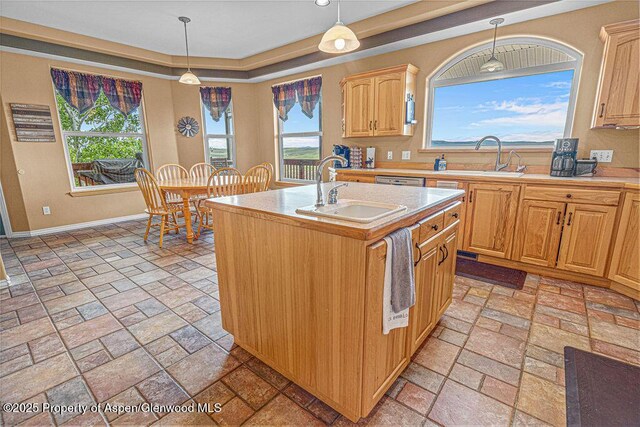 289 Lewis Ln, Craig, CO 81625 - kitchen with a sink, light countertops, hanging light fixtures, and an island with sink
