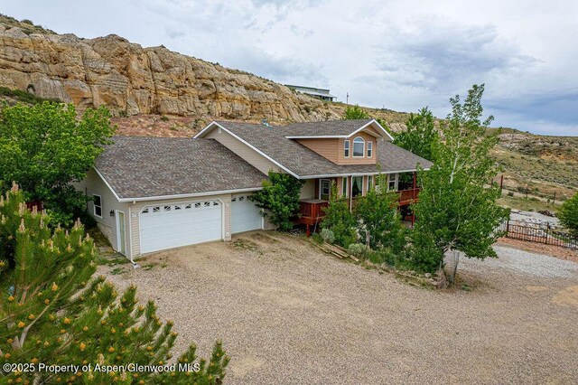 289 Lewis Ln, Craig, CO 81625 - traditional-style house with dirt driveway, an attached garage, and a shingled roof