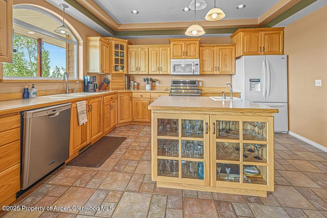 289 Lewis Ln, Craig, CO 81625 - kitchen featuring appliances with stainless steel finishes, a sink, light countertops, stone tile flooring, and recessed lighting
