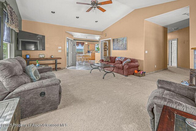 289 Lewis Ln, Craig, CO 81625 - carpeted living area featuring a ceiling fan, vaulted ceiling, plenty of natural light, and baseboards