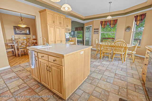 289 Lewis Ln, Craig, CO 81625 - kitchen with baseboards, a tray ceiling, and stone tile floors