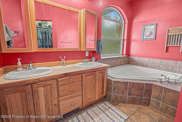 289 Lewis Ln, Craig, CO 81625 - full bathroom with a bath, double vanity, and a textured wall