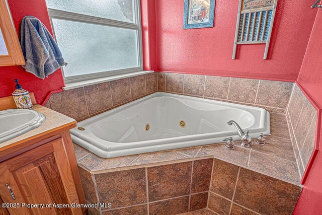 289 Lewis Ln, Craig, CO 81625 - bathroom with a jetted tub, vanity, and a textured wall