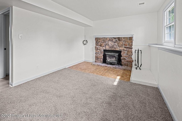 813 Finley Ln, Craig, CO 81625 - unfurnished living room featuring a wood stove and carpet flooring