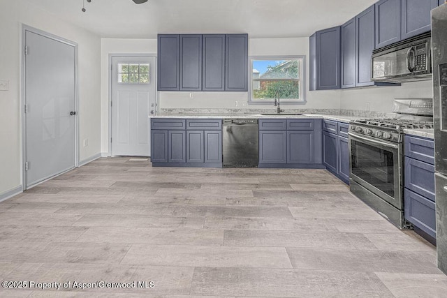 813 Finley Ln, Craig, CO 81625 - kitchen featuring appliances with stainless steel finishes, light wood-style floors, and light countertops