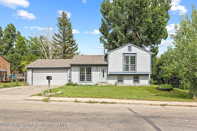 813 Finley Ln, Craig, CO 81625 - split level home with concrete driveway, a garage, a front yard, a chimney, and roof with shingles