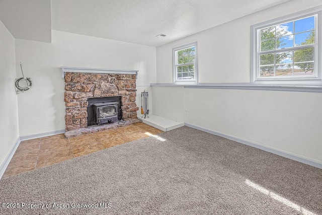 813 Finley Ln, Craig, CO 81625 - unfurnished living room featuring a wood stove and carpet flooring