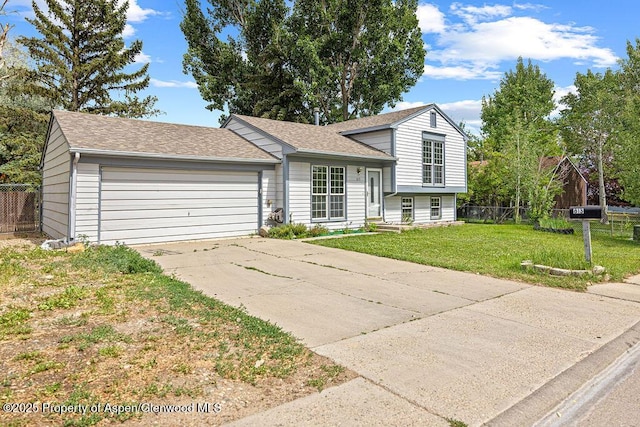 813 Finley Ln, Craig, CO 81625 - split level home with a garage, driveway, and a shingled roof
