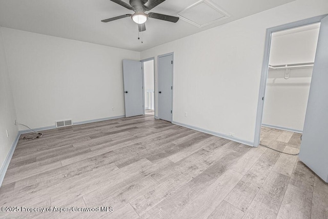 813 Finley Ln, Craig, CO 81625 - unfurnished bedroom featuring wood finished floors, a walk in closet, a ceiling fan, and a closet