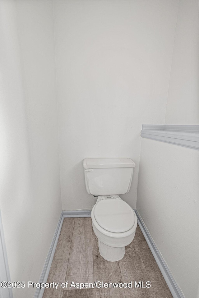 813 Finley Ln, Craig, CO 81625 - bathroom featuring toilet and wood finished floors
