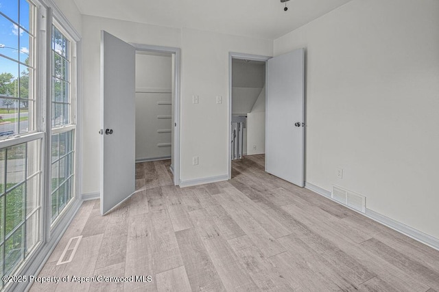 813 Finley Ln, Craig, CO 81625 - unfurnished bedroom featuring light wood-style floors, a walk in closet, and a closet
