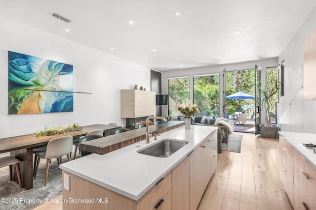 155 Lone Pine Rd Unit 2, Aspen, CO 81611 - kitchen with light brown cabinets, modern cabinets, light wood-type flooring, open floor plan, and recessed lighting