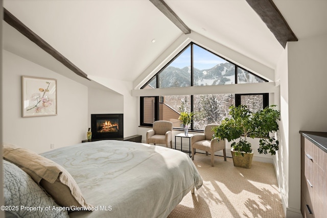 155 Lone Pine Rd Unit 2, Aspen, CO 81611 - carpeted bedroom featuring a mountain view, beam ceiling, a glass covered fireplace, and high vaulted ceiling