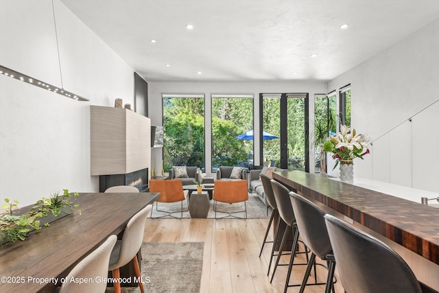 155 Lone Pine Rd Unit 2, Aspen, CO 81611 - dining space with a glass covered fireplace, recessed lighting, and light wood finished floors