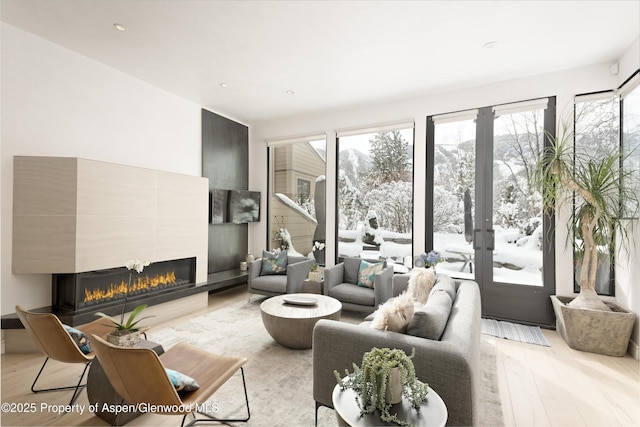 155 Lone Pine Rd Unit 2, Aspen, CO 81611 - living room featuring a glass covered fireplace, light wood-style floors, and recessed lighting